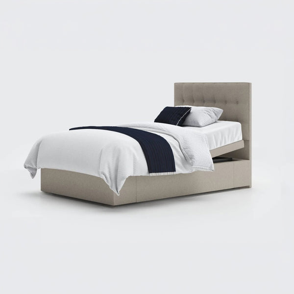 Opera Beds Emerald Motion Adjustable Divan Bed with white bedding and dark blue throw, plain background, front view.