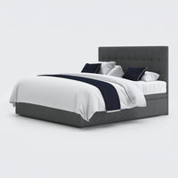 Emerald Motion Adjustable Divan Bed with tall headboard, white bedding and navy accents, front view.