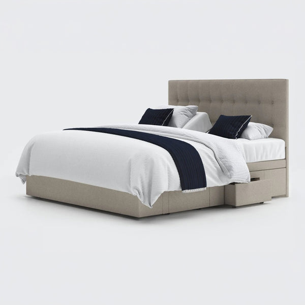 Emerald Motion adjustable divan bed with white bedding, navy accents, built-in drawers and wireless handset, front view.