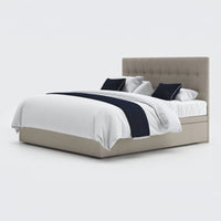 Opera Beds Emerald Motion Adjustable Divan Bed with tufted headboard, white bedding and navy accents, front view.