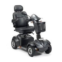 Drive Envoy 8 Scooter with padded seat, armrests, headrest and front basket on four wheels, side view.