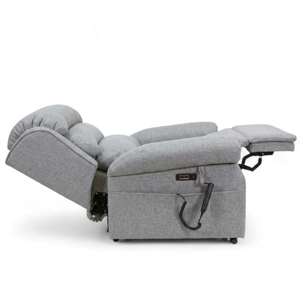 Repose Seating ErgoRise Dual Motor Tilt-In-Space Chair reclined with footrest extended and remote control visible, side view.