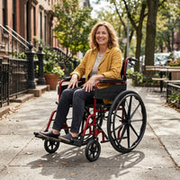 Woman using Days Escape Lite Self Propel Wheelchair outdoors on city pavement with brownstone buildings, in use view.