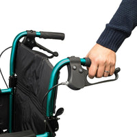 Hand holding handle and brake of Days Escape Lite Wheelchair, white background, close-up view.