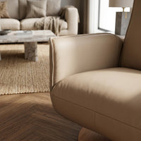 Modern Motion Fitzroy Riser Recliner Swivel Chair next to sofa, marble coffee table and woven rug on wooden floor, front view.