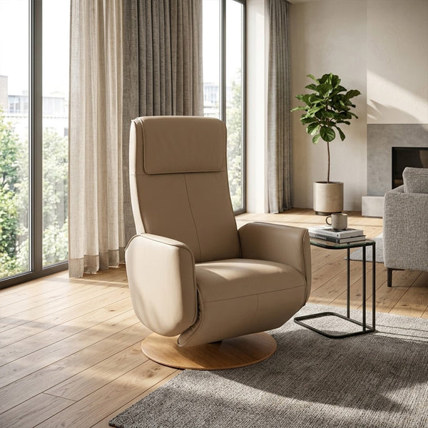 Modern Motion Fitzroy riser recliner swivel chair next to window in bright room with wood floors and potted plant, angled view.
