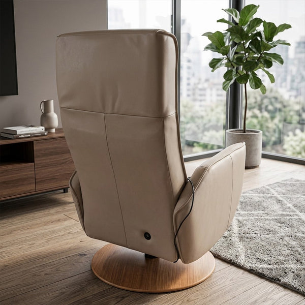 Modern Motion Fitzroy Riser Recliner Swivel Chair facing away in a living room with large windows and a green plant, rear view.