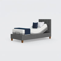 Flyte Adjustable Bed with Zero Gravity feature, white bedding, navy blanket, two pillows, front view.