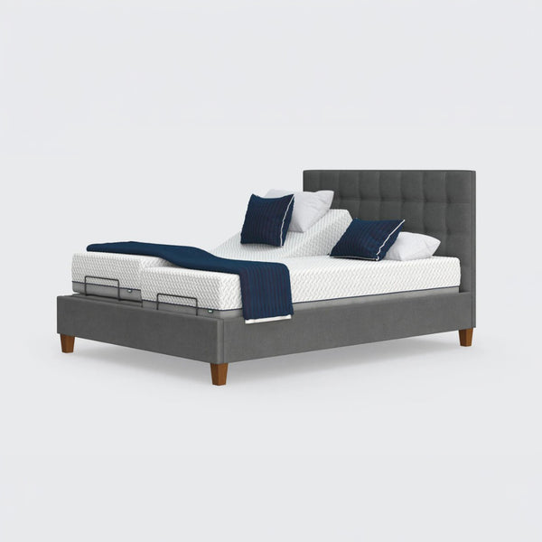 Opera Beds Flyte adjustable bed with split mattresses, Zero Gravity feature, wooden legs, and blue and white bedding, front view.