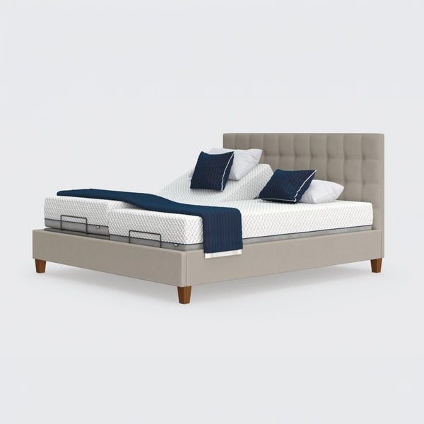Opera Beds Flyte Adjustable Bed with split mattress, white bedding, navy pillows and navy throw blanket, front view.