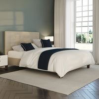 Flyte Adjustable Bed by Opera Beds with white bedding, navy accents and herringbone wood floors, bedroom setting, front view.
