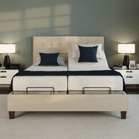 Opera Beds Flyte Adjustable Bed with white bedding, navy pillows, nightstands; zero gravity and anti-snore settings, front view.