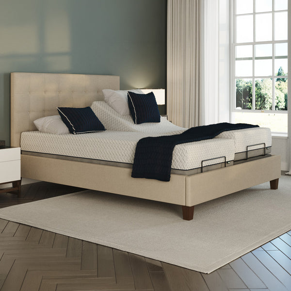 Flyte Adjustable Bed by Opera Beds with white bedding and dark pillows in a modern bedroom, natural light, front view.