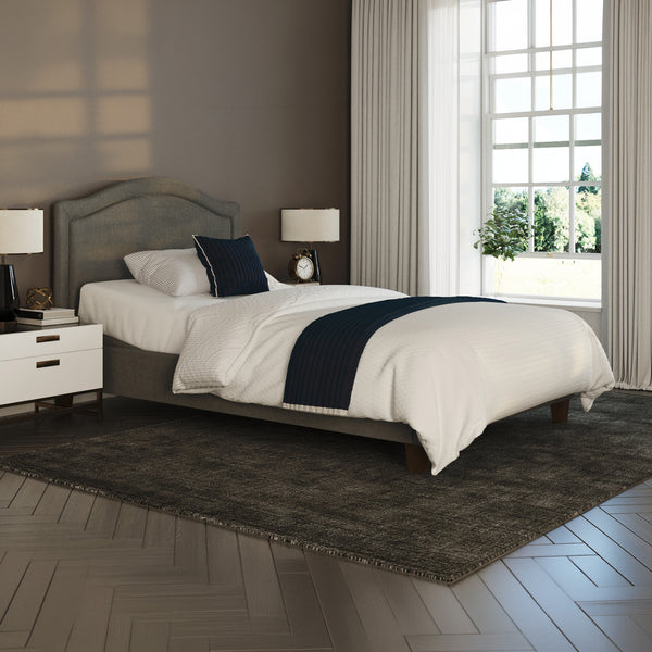 Flyte Adjustable Bed by Opera Beds with white bedding, blue accents, and sheer-curtained window in a modern bedroom, front view.