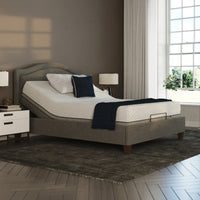 Opera Beds Flyte Adjustable Bed with white bedding, dark pillows, nightstands, lamps and sheer curtains, front view.