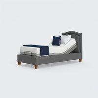 Opera Beds Flyte Adjustable Bed with Zero Gravity, white mattress and navy bedding on plain white background, front view.
