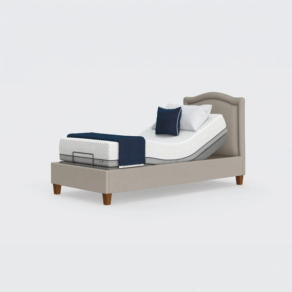 Opera Beds Flyte adjustable bed with zero gravity, white mattress, blue blanket, pillows on upholstered frame, front view.