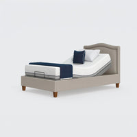 Opera Beds Flyte Adjustable Bed with Zero Gravity setting, raised headrest, white mattress, blue and white pillows, front view.