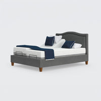 Opera Beds Flyte Adjustable Bed with white bedding, blue pillows, and a blue throw on a plain background, front view.