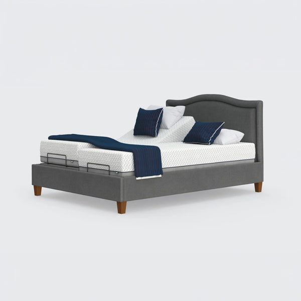 Opera Beds Flyte Adjustable Bed with white bedding, blue pillows, and a blue throw on a plain background, front view.