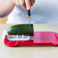 ORNAMIN Food Preparation Aid with built-in guide slicing cucumber, in use view.