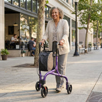 Woman using NRS Freestyle 3 Wheel Rollator with adjustable ergonomic handles outside a café, in use.