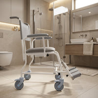 Prism Medical Freeway T40 Mobile Shower Chair in accessible bathroom with glass shower and sink, front view.