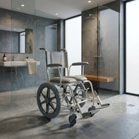 Prism Medical Freeway T60 Self-Propel Shower Chair in accessible bathroom with shower and sink, centre view.