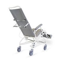 Prism Medical Freeway T80 Reclining Shower Chair with armrests and large swivel wheels, rear-side view.