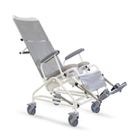 Freeway T80 reclining shower chair with armrests, footrests and four wheels, flame-retardant design, side view.