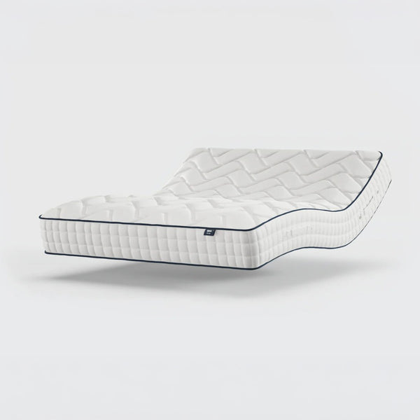Opera Beds Gel 1000 Adjustable Mattress elevated and curved, quilted design visible against plain background, side view.