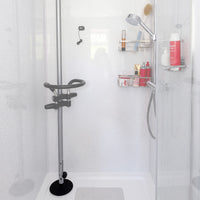 Accessible shower featuring GRIPO Support Pole, wall shelf for toiletries and handheld showerhead, front view.
