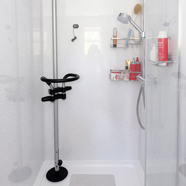Shower with GRIPO Circular Grip 360° support, anti-slip base, handheld showerhead, and toiletries shelves, front view.