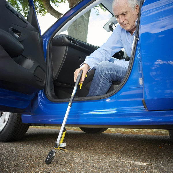 Helping Hand Classic Pro Folder grabber picking up car keys by a man outside his car, in use view.