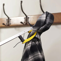 Helping Hand Classic Pro Reacher gripping a hooded plaid shirt near a wooden coat rack with metal hooks, in use view.