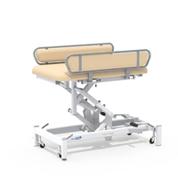 Medi-Plinth hydraulic changing table with MRSA-resistant side rails and adjustable metal frame on wheels, side view.