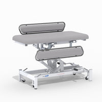 Medi-Plinth hydraulic changing table with MRSA-resistant upholstery, side rails and wheels, side view.