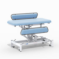 Medi-Plinth Hydraulic Changing Table with MRSA-resistant upholstery, metal rails and wheels, side view.