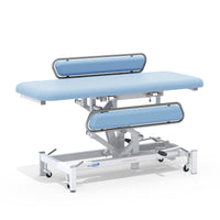 Medi-Plinth hydraulic changing table with MRSA-resistant upholstery, cushioned top and wheeled base, side view.
