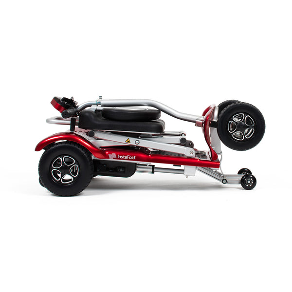 Drive Instafold Folding Mobility Scooter, compact with black wheels and silver frame, folded, side view.
