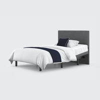 Opera Beds Jade Motion Adjustable Bed with dark headboard, white bedding, navy throw and two pillows, front view.