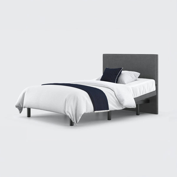 Opera Beds Jade Motion Adjustable Bed with dark headboard, white bedding, navy throw and two pillows, front view.