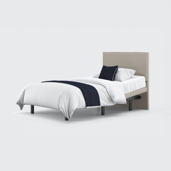 Opera Beds Jade Motion Adjustable Bed with headboard, white bedding and navy throw, front view.