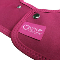 Tabard Style Adult Bib by Care Designs with metal snaps and heart logo label, close-up.