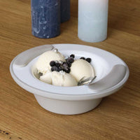 ORNAMIN Keep Warm Bowl with non-slip base holding ice cream, berries, and spoon on wooden table beside candles, front view.
