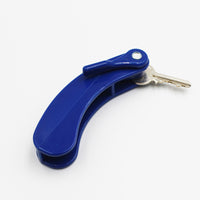 Key turner holding two metal keys with an easy-grip handle, designed for turning keys easily, shown in close-up.