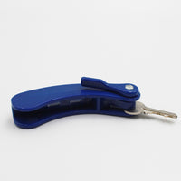Key turner for two keys with comfort grip handle and metal key inserted, white background, front view.