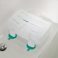 Helping Hand Kingfisher Bath Seat with non-slip suction cups placed in a bathtub near the drain, angled view.