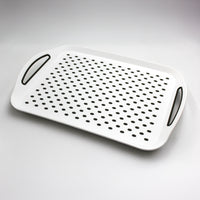 Able2 Stayput Anti-Slip Tray with handles and spaced holes on a textured surface, front view.