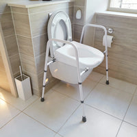 NRS Mowbray Lite Toilet Aid with handrails next to a toilet in a modern bathroom, tiled walls and floor, front view.
